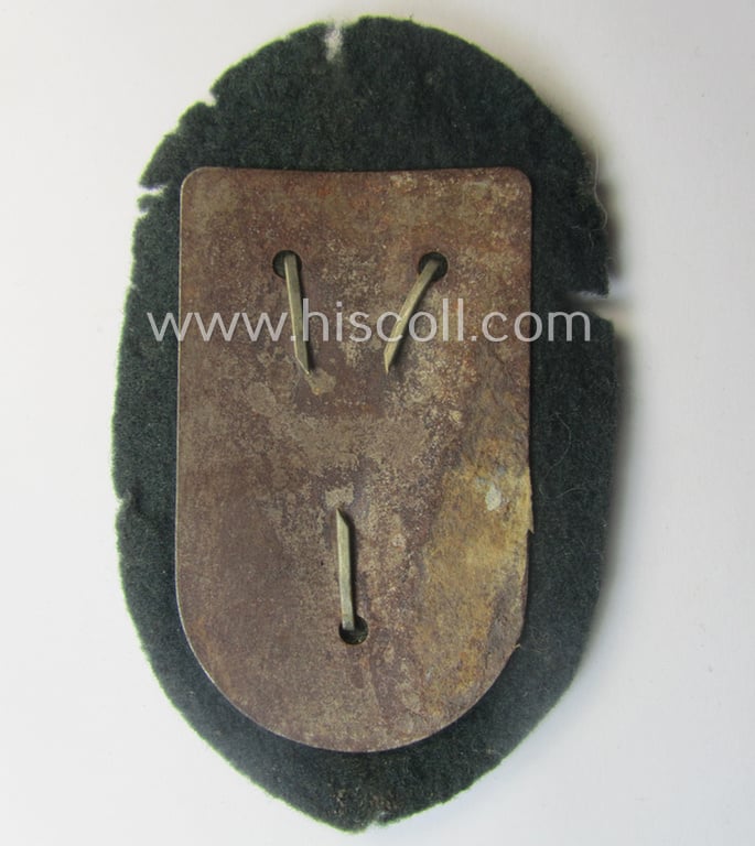 Superb - and truly rarely encountered! - WH (Heeres ie. Waffen-SS) so-called: 'Cholm'-campaign-shield as executed in magnetic, so-called: 'Eisenblech' being a 'Short M-variant-pattern' shield that comes in a clearly used- ie. worn-, condition