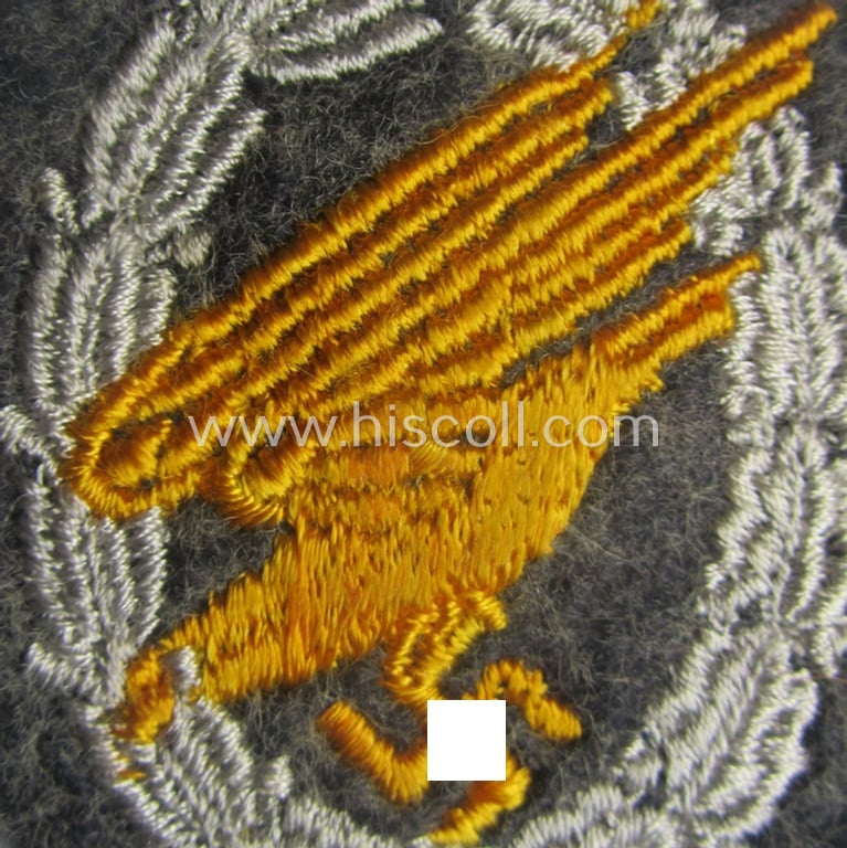 WH (Luftwaffe) 'Fallschirmschützen-Abzeichen in Stoff' (or: cloth-based paratroopers' jump-badge) that is nicely machine-embroidered and being of the so-called: 'padded version'