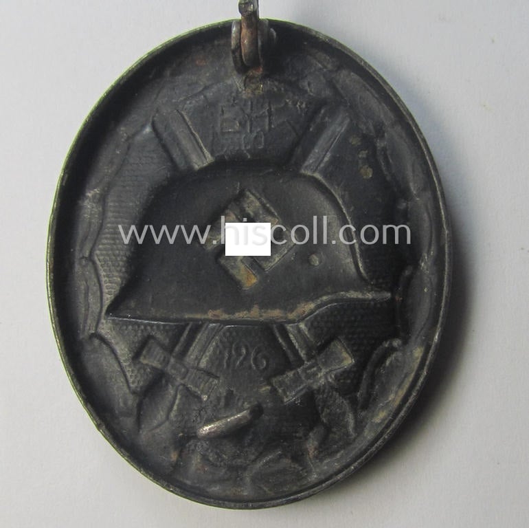 Dual-maker- (ie. 'E.H.'- and/or: '126'-) marked example of a black-class wound-badge (or: 'Verwundeten-Abzeichen in Schwarz') being an example that was produced by the maker (ie. 'Hersteller') named: 'Eduard Hahn'