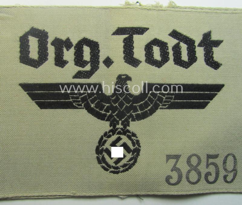Superb - and rarely seen! - OT- (ie.: 'Organisation Todt'-) related, greyish-coloured and 'BeVo'-woven armband (ie. 'Ärmbinde') showing a detailed eagle-device and depicting the text: 'Org.Todt.' (and printed serial-number: '3859')
