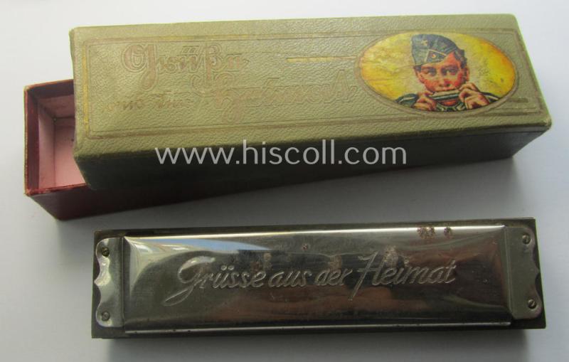 TR-era- (ie. 'Deutsche Wehrmacht'-) related harmonica entitled: 'Grüsse aus der Heimat' that came stored in its original and/or carton-based box ie. etui