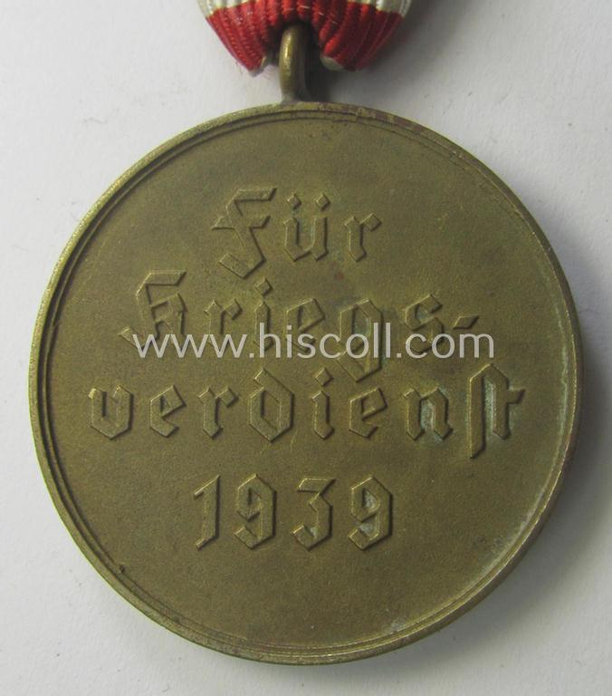 Medal-set: 'Kriegsverdienstmedaille 1939' being a (typical) non-maker-marked- (and 'Buntmetall'-based) specimen that came mounted onto its (scarcely seen!) bright-red-coloured- and/or Austrian-styled ribbon (ie. 'Bandabschnitt')