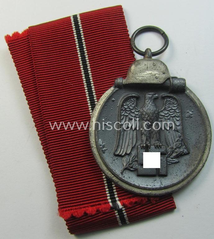Neat medal-set: 'Winterschlacht im Osten 1941-42' being a non-maker-marked- (and/or typical 'Feinzink'-based) specimen that comes together with its (minimally confectioned) ribbon (ie. 'Bandabschnitt')
