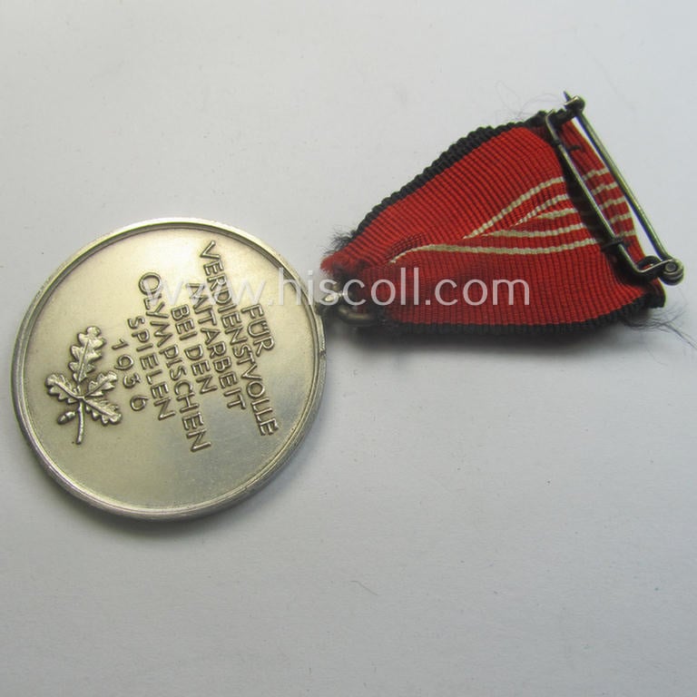 'Deutsche Olympia-Erinnerungsmedaille 1936' being a non-maker-marked example that comes mounted onto its original ribbon (ie. 'Bandabschnitt')