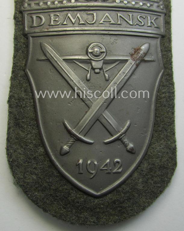Superb example of a - fairly scarcely encountered! - WH (Heeres ie. Waffen-SS) 'Demjansk'-campaign-shield as executed in typical magnetic, so-called: 'Eisenblech' (and being of the 'missing-log' variant-pattern)