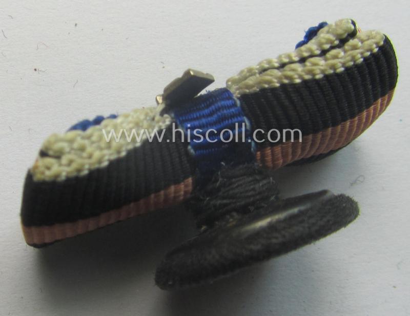 Interesting, 3-pieced WH (Luftwaffe) related ribbon-bar (ie. 'Feld- o. Bandspange') showing a: 'WH-DA 4. Stf.' and an Austrian- and/or Czech 'Anschluss'-medal and that comes mounted onto its specific 'button-hole'-set-up