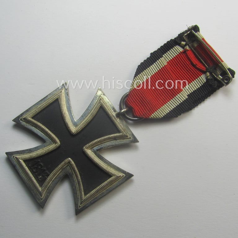 'Eisernes Kreuz II. Klasse' being a neatly maker- (ie. 'L/18'-) marked example that comes mounted onto its period- and confectioned ribbon (ie. 'Bandabschnitt') as was produced by the maker (ie. 'Hersteller'): 'B.H. Mayer's Kunstprägeanstalt'