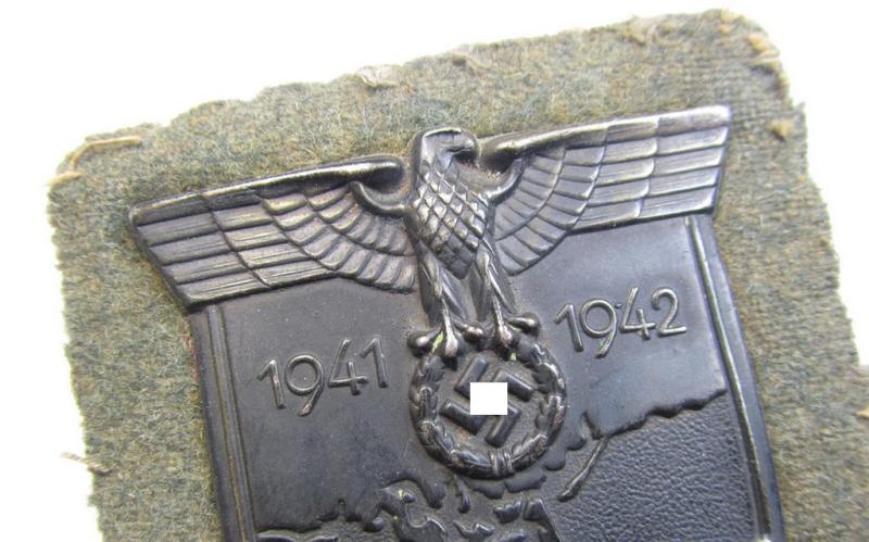 Attractive, WH (Heeres o. Waffen-SS) 'Krim'-campaign-shield that comes mounted onto its original, field-grey-coloured 'backing' and that comes in an issued-, moderately worn and/or carefully tunic-removed-, condition