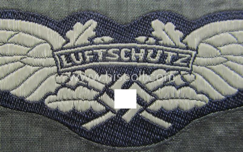 Attractive - and scarcely encountered! - EM- (ie. NCO-) pattern, so-called: 'Luftschutz' (ie. RLB-) breast-badge (ie. 'Brustabzeichen') as executed in so-called: 'BeVo'-weave-pattern and that comes in a 'virtually mint- ie. unissued' conditio...