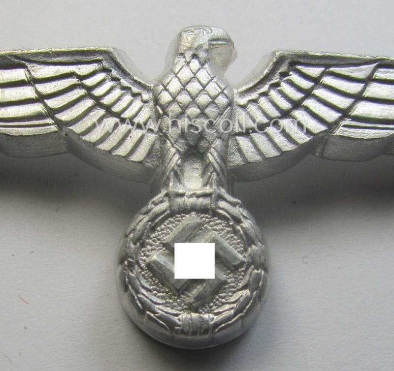 WH (Heeres) bright-silver-toned (ie. aluminium-based), EM- (ie. NCO- or officers') type visor-cap-eagle being a non-maker-marked example that comes in a never used- ie. (I deem) never cap-attached, condition
