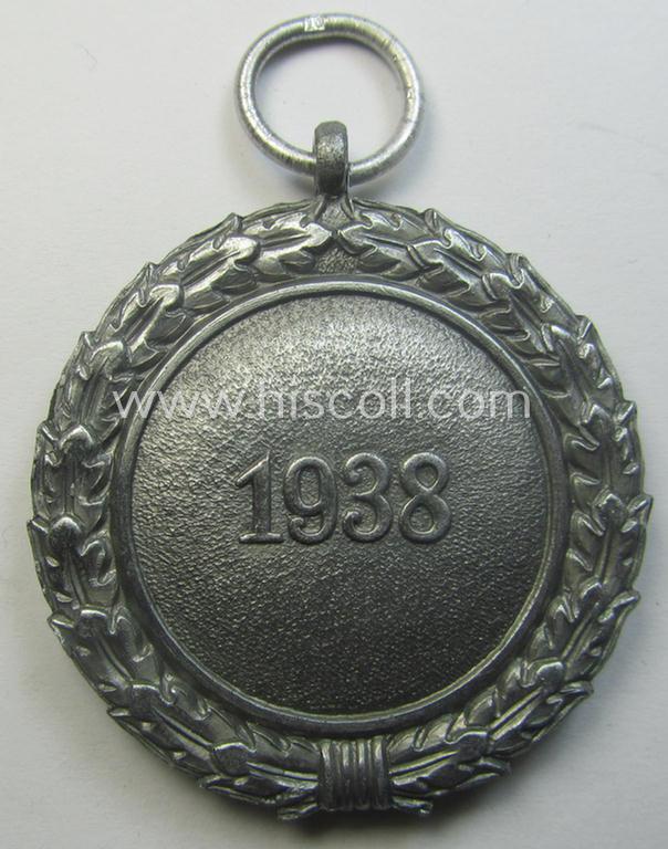 'Luftschutz-Ehrenzeichen 2. Stufe' being a maker- (ie. '10'-) marked example, as executed in (heavy) zinc-based metal (ie. 'Feinzink') and that came together with its period ribbon (ie. 'Bandabschnitt')