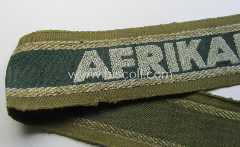 Attractive, 'BeVo'-like cuff-title (ie. 'Ärmelstreifen') entitled: 'Afrikakorps' being a with certainty issued and truly worn example that comes in an overall nice- (ie. minimally shortened-  and/or once tunic-attached-), condition