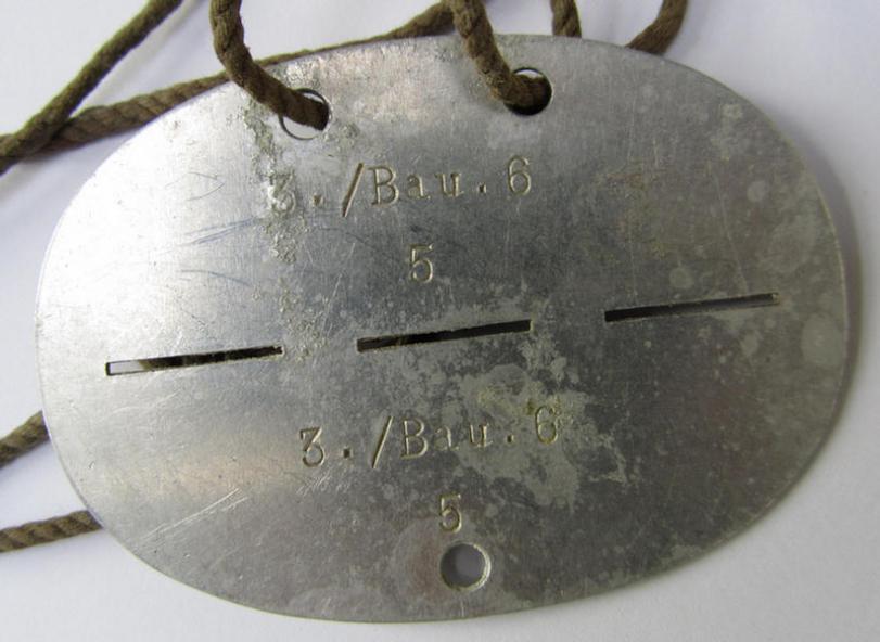 Neat, aluminium-based, WH (Luftwaffe or Heeres) 'Pioniere'-/'Bau' (ie. engineers-) related ID-disc, bearing a stamped unit-inscription- ie. designation that reads: '3./Bau.6' - nice, albeit clearly used ie. worn-, condition!