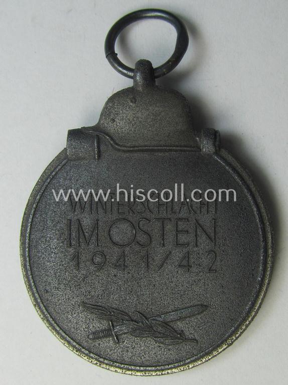 Attractive medal-set: 'Winterschlacht im Osten 1941-42' being a maker- (ie. '13'-) marked- (and/or 'Feinzink'-based) specimen by the maker: 'Gustav Brehmer' and that comes together with its (non-confectioned) ribbon (ie. 'Bandabschnitt')