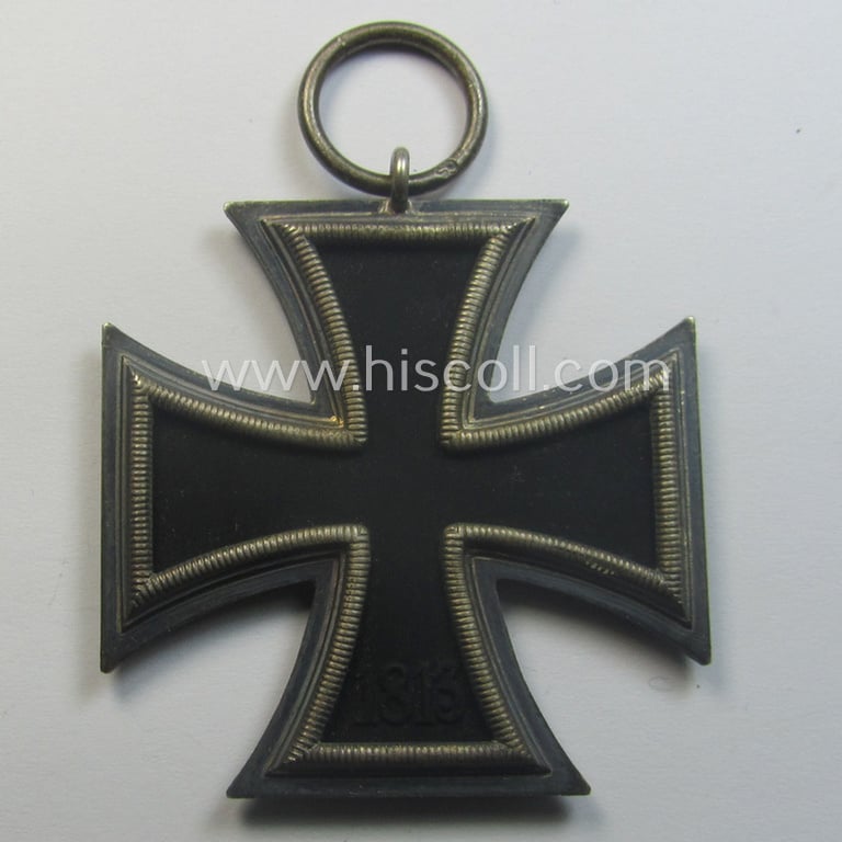 'Eisernes Kreuz 2. Kl.' (ie. Iron Cross 2nd Class) being a maker- (ie. '65'-) marked example that comes stored in its period 'Zellstoff'-based pouch by the: 'Klein & Quenzer'-company