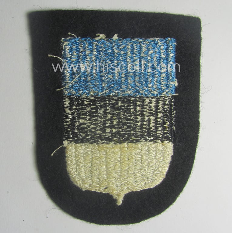 Waffen-SS 'volunteer'-arm-shield as was intended for usage by soldiers of the: '20. Waffen-Grenadier-Division der SS' (ie. 'estnische Nr. 1') and that comes in a 'virtually mint- ie. unissued', condition