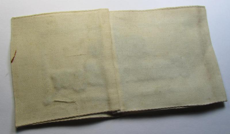 Neat, beige/white-coloured- and/or linnen-based armband (ie. 'Armbinde') as was executed in the 'thicker-styled' fabric as was intended for WH (Heeres) staff-members working as: 'Hilfs-Krankenträger'