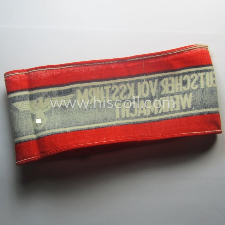Typically printed- and/or later-war-period, bright-red- and/or black-coloured so-called: 'Deutscher Volkssturm'-armband (ie. 'Armbinde') that comes in an overall very nice- (I deem hardly used- nor worn- ie. 'virtually mint'-), condition