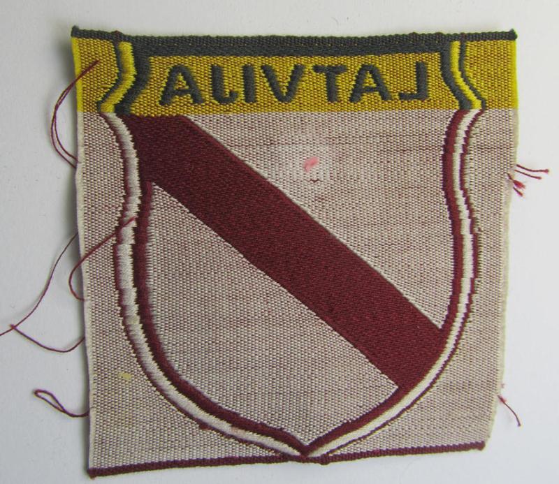 Superb - and truly rarely seen! - locally produced(!), 'Waffen-SS'-type armshield as executed in the so-called: 'semi-BeVo'-pattern entitled: 'Latvia' as was merely intended for usage by the members of the: 'Latvian Legion'