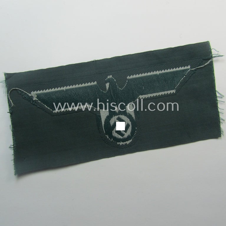 WH (Heeres) early- (ie. pre-war-) period- and/or greyish-coloured breast-eagle of the: 'M36'- (ie. 'M40'-) pattern as was executed in the 'BeVo'-weave pattern on a darker-green-coloured background