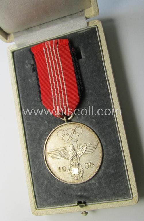 Superb, 'Deutsche Olympia-Erinnerungsmedaille 1936' being a non-maker-marked example that comes mounted onto its original ribbon (ie. 'Bandabschnitt') and that comes stored in its typical, beige-white-coloured etui as issued and stored for decade...