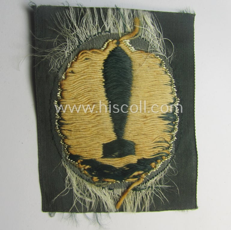 'BeVo'-woven version of a WH (Heeres) so-called: trade- and/or special-career insignia as intended for a: 'Nebelwerfer Richtkannonier' (or: qualified smoke-troops canon-operator)