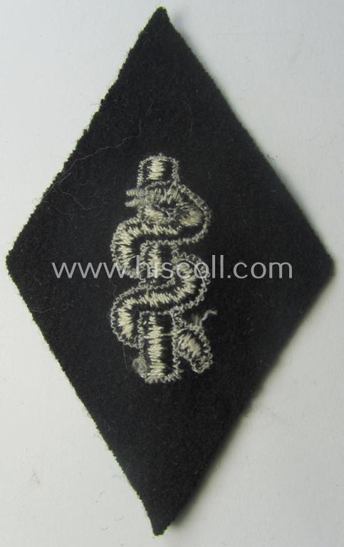 Waffen-SS-pattern, machine-embroidered and/or black- and white-coloured sleeve-insignia (ie. 'Ärmelraute') depicting a so-called: 'Aesculapus'-sign as was used and intended to signify membership within the 'SS-Sanitätsdienst'