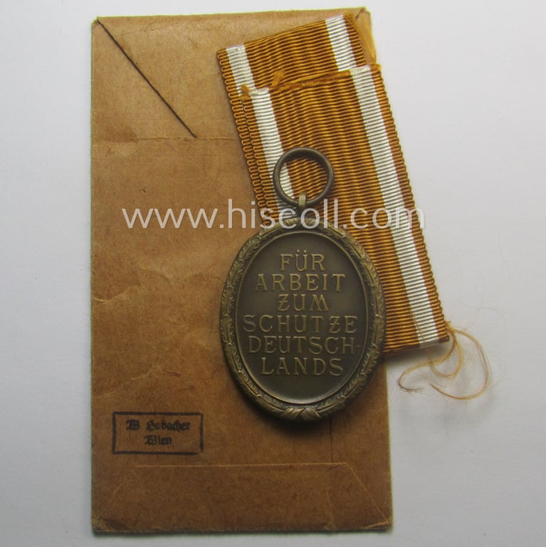 Medal-set: 'Deutsches Schutzwall Ehrenzeichen' (aka: 'Westwall'-medal) being a (typical) non-maker-marked- and/or: typical 'Buntmetall'-based specimen that comes packed in its original pouch of issue by the: 'Wilh. Hobacher'-company