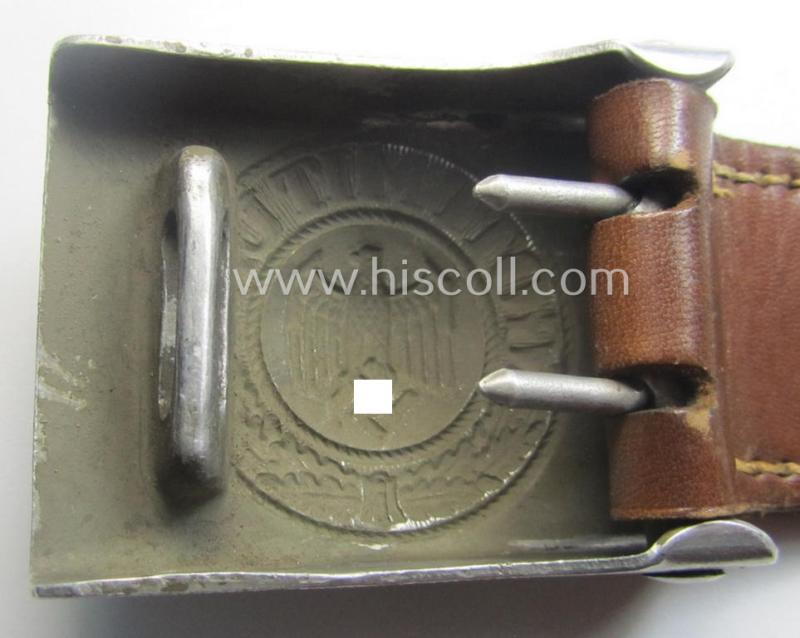 WH (Heeres) 'standard-pattern', field-grey-toned- and aluminium-based belt-buckle being a maker- (ie. 'Jul. Kremp'-) marked- and/or: '1939'-dated example that comes mounted onto its leather-based tab