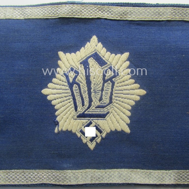 Darker-blue-coloured, RLB (or: 'Reichsluftschutzbund') so-called: 'Amtsträger-Armbinde für Führer' depicting the typical 'RLB'-logo (with lettering) and that comes in a just moderately used- ie. worn, condition