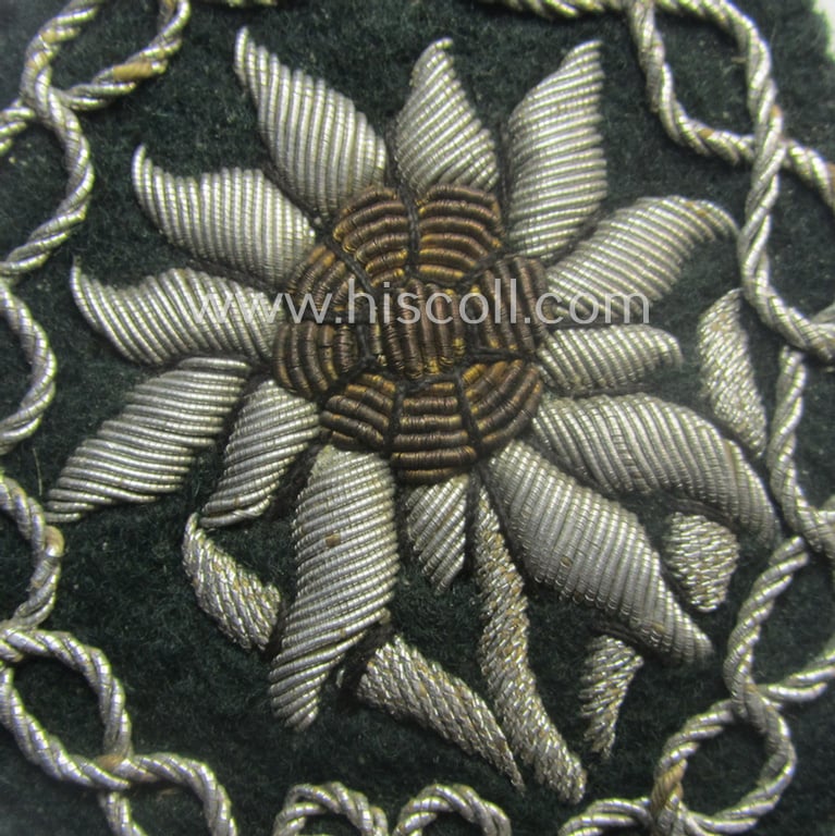 Superb - and just moderately used! - WH (Heeres) neatly hand-embroidered- and/or typical officers'- (ie. 'variant'-) pattern so-called: 'Edelweiss'-arm-badge (as specifically intended for usage by an officer serving within the 'Geb.-Jäger-Trpn.')