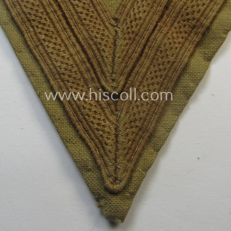 Scarcely found, WH (Luftwaffe) tropical-styled, 'Armwinkel' (or: arm-chevron) as executed on typical beige- ie. tan-coloured linnen as was specifically intended for usage by a soldier with the rank of an: 'Obergefreiter'