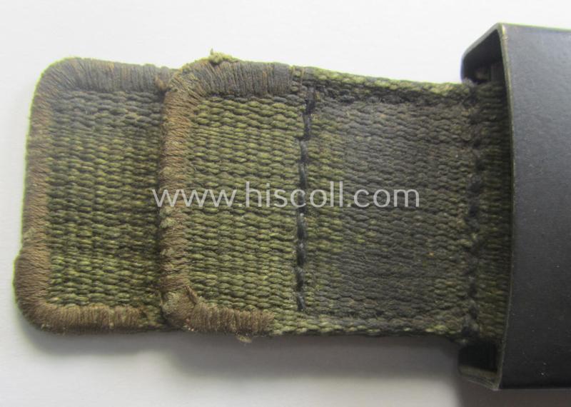 WH (Heeres) 'tropical-issued' belt-buckle being a non-maker-marked (and/or period re-sprayed!) bluish-coloured example that comes mounted onto its original, greenish-coloured- (and/or: 'webbing'-based-) tab