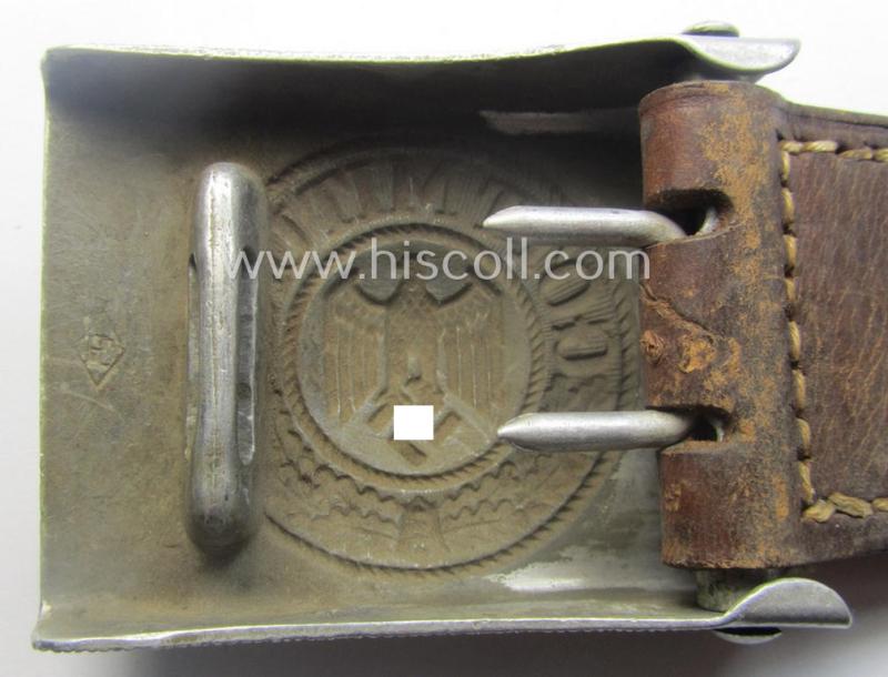 WH (Heeres) 'standard-pattern', field-grey-toned- and aluminium-based belt-buckle being a maker- (ie. 'Paulmann & Crone'-) marked- and/or: '1938'-dated example that comes mounted onto its leather-based tab
