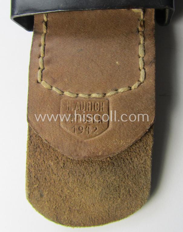 WH (Luftwaffe) bluish-grey-coloured, steel-based belt-buckle, being a maker- (ie. 'H. Aurich'-) marked- and/or: '1942'-dated example that comes mounted onto its leather-based tab and that comes in a 'virtually mint' condition