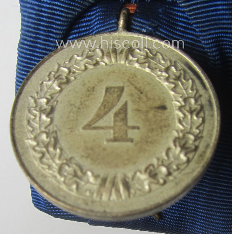 Bright silver-toned, WH (Luftwaffe) so-called: 'Einzelspange' showing a: 'WH-Dienstauszeichnung 4. Stufe' (as was intended for 4 years of loyal-service) and that shows a detailed, Luftwaffe-type-eagle-device period-attached