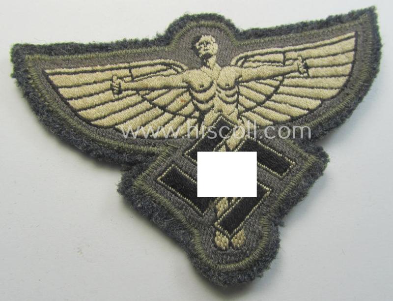 Bluish-grey-coloured, so-called: N.S.F.K.- (or: 'National Socialistisches Flieger Korps') breast-badge being a nicely BeVo-woven- (and enlisted-mens'-pattern) example that comes mounted on its piece of bluish-coloured wool