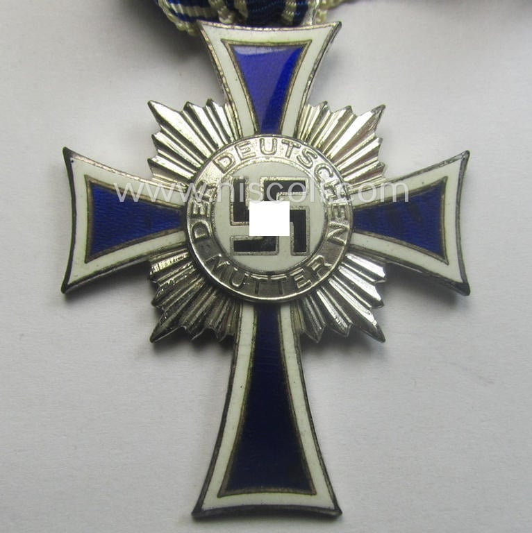 'Ehrenkreuz der deutschen Mutter - zweite Stufe' (or: silver-class mothers'-cross) that came mounted onto its long-sized ribbon and that came stored in its period pouch by the maker: 'Moriz Hausch A.-G. - Pforzheim'