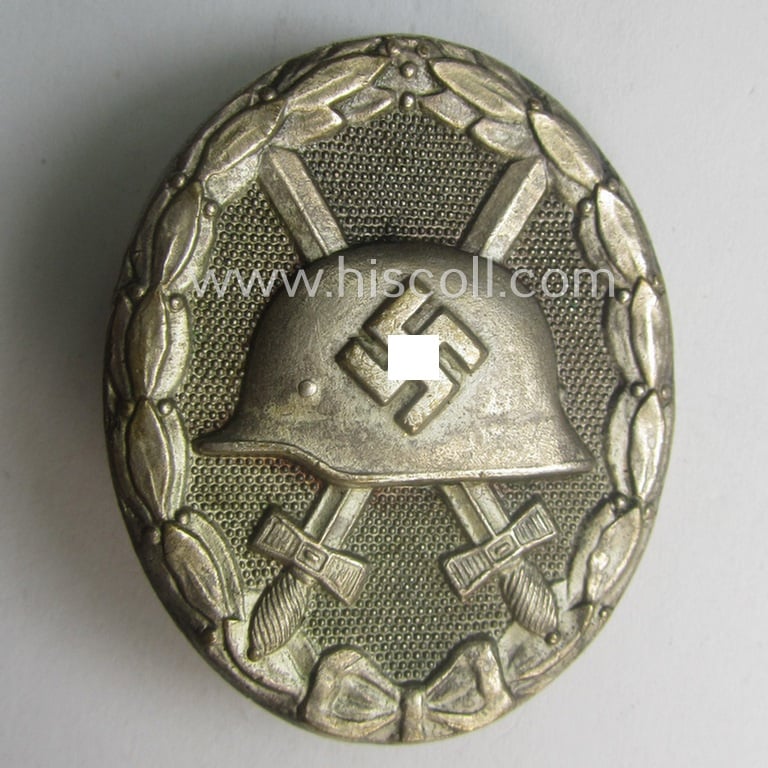Silver-class wound-badge- (or: 'Verwundeten-Abzeichen in Silber'-) set comprising of a non-maker-marked example as produced by an unidentified 'Hersteller' and that comes stored in its typical 'LDO'-styled etui