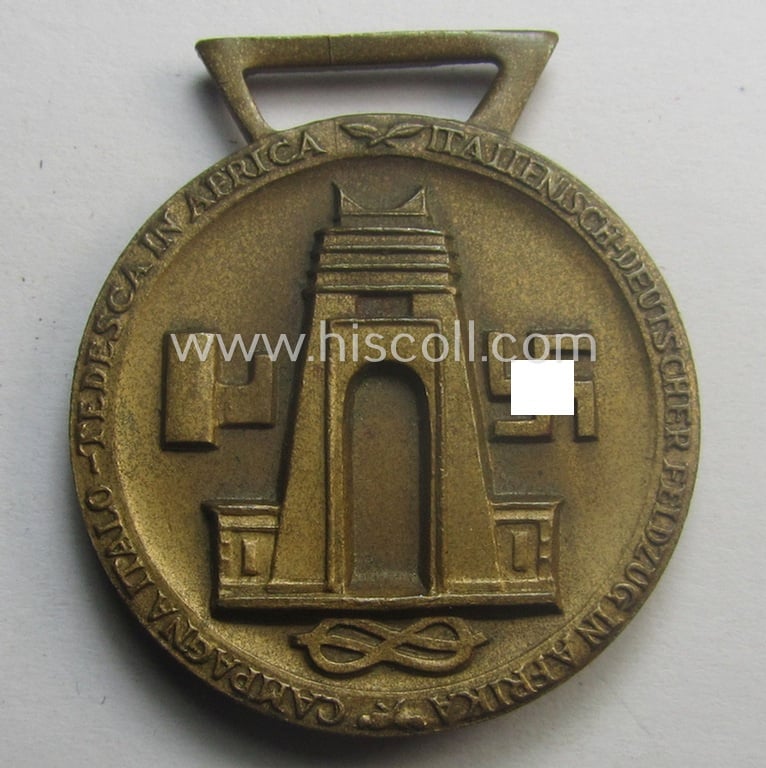 Golden-bronze-coloured (and 'Buntmetall'-based!) example of a: 'Deutsch-Italienische Feldzugsmedaille' (or: German-Italian campaign-medal) that came together with its (full length- and 'virtually mint- ie. unissued') piece of original ribbon