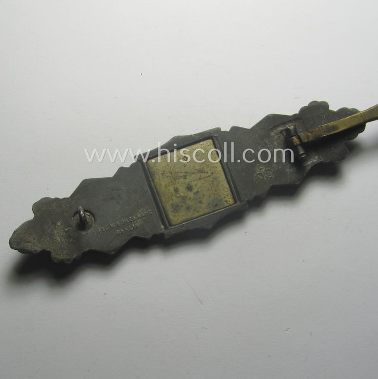 'Nahkampfspange in Bronze' (or: bronze-class close-combat clasp ie. CCC) being a (typical) maker-marked- and/or minimally converse-shaped specimen as was produced by the maker- (ie. 'Hersteller') 'Friedrich Linden' (ie. 'FLL')