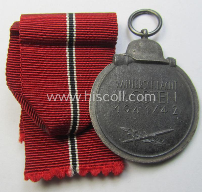 Attractive medal-set: 'Winterschlacht im Osten 1941-42' being a maker- (ie. '14'-) marked- (and/or 'Feinzink'-based) specimen by the maker: 'L.Chr. Lauer' and that comes together with its (minimally confectioned) ribbon (ie. 'Bandabschnitt'...