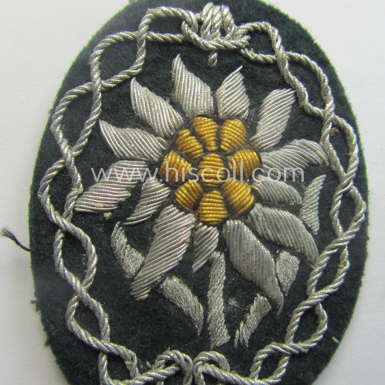 Moderately used, WH (Heeres) neatly hand-embroidered- and/or typical officers'- (ie. 'variant'-) pattern so-called: 'Edelweiss'-arm-badge (as specifically intended for usage by an officer serving within the 'Geb.-Jäger-Trpn.'