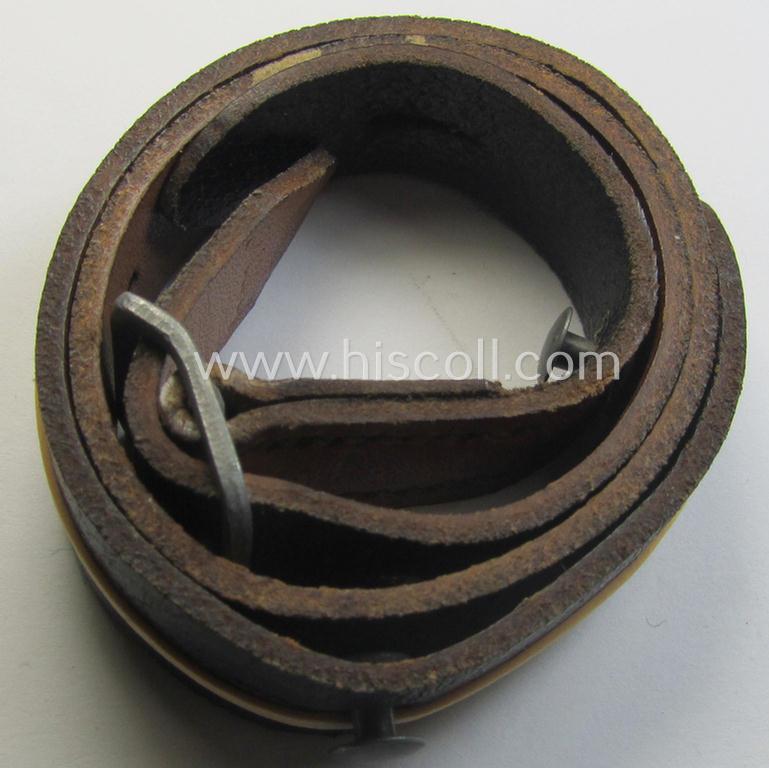 Early-war-period- and 'standard-issue'-pattern, black-coloured- and/or leather-based WH helmet-strap (ie. 'Riemen für Stahlhelm') being an: 'BMD 41'-marked example that comes in a never mounted ie. 'virtually mint' condition