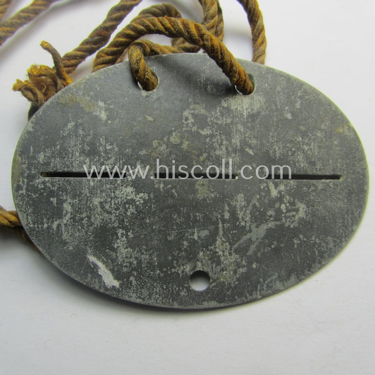 Zinc-based, WH (LW) ie. 'Flieger'-related ID-disc bearing the clearly stamped unit-designation that simply reads: '12. Flg.Rgt. 53' (and as such belonging to a staff-member serving within the: 'Luftgau-Feld-Regiment Belgien-Nordfrankreich')
