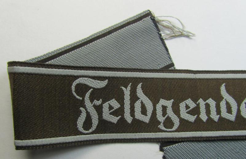 Superb - and scarcely encountered! - example of a WH (Heeres) cuff-title ie. armband (ie. 'Ärmelstreifen') entitled: 'Feldgendarmerie' (being a typical 'semi-BeVo'-woven!) example that comes in a minimally shortened, condition