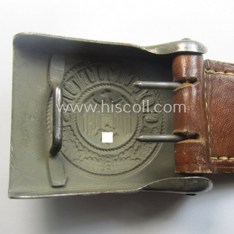 WH (Heeres) field-grey-coloured- and/or steel-based belt-buckle, being a maker- (ie. 'J. C. Maedicke'-) marked- and/or: '1941'-dated example that comes mounted on its leather-based tab and that comes in a moderately used- ie. worn, condition