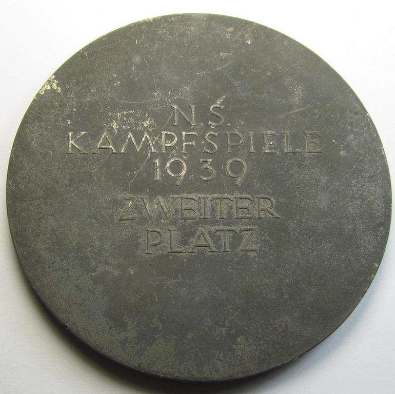 Attractive, larger-sized- and greyish-silver-toned so-called: award-plaque (or: 'Erinnerungs- o. nichttragbare Medaille') showing a 'Reichsadler'- and swastika-sign and illustration of a mother and child coupled with the text: 'Reichsparteitag 1...