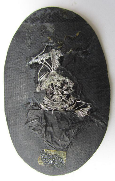 Superb, WH (Heeres) trade- or special-career insignia, being a very detailed- and/or hand-embroidered example on darker-green-coloured wool, as was intended for usage by a: 'Steuermann' (ie. enigineer boat-pilot or helmsman)