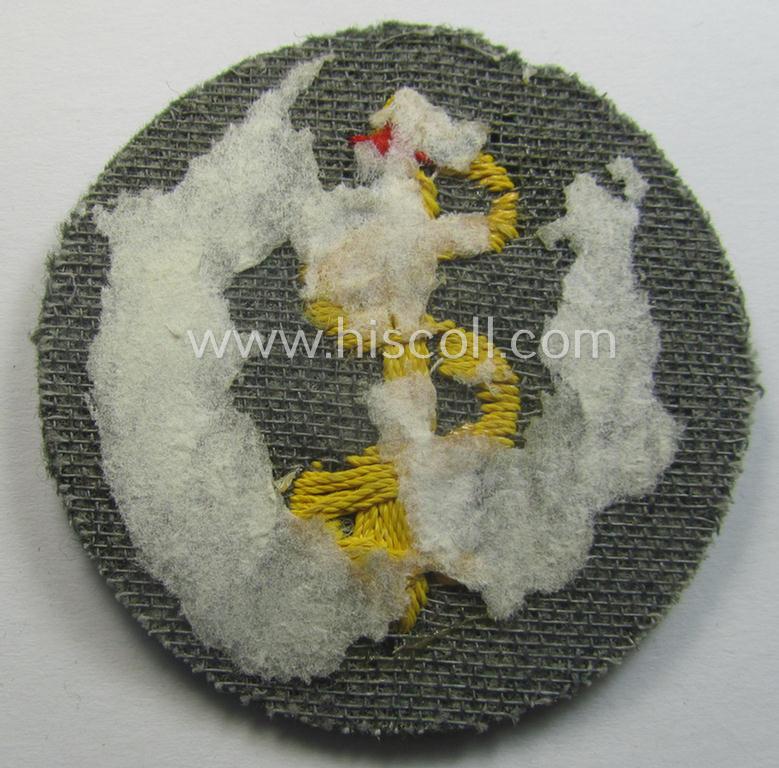 WH (Heeres) so-called: trade- and/or special-career arm-insignia as was intended for a: 'Sanitäter' being a neatly hand-embroidered specimen on a field-grey-coloured background